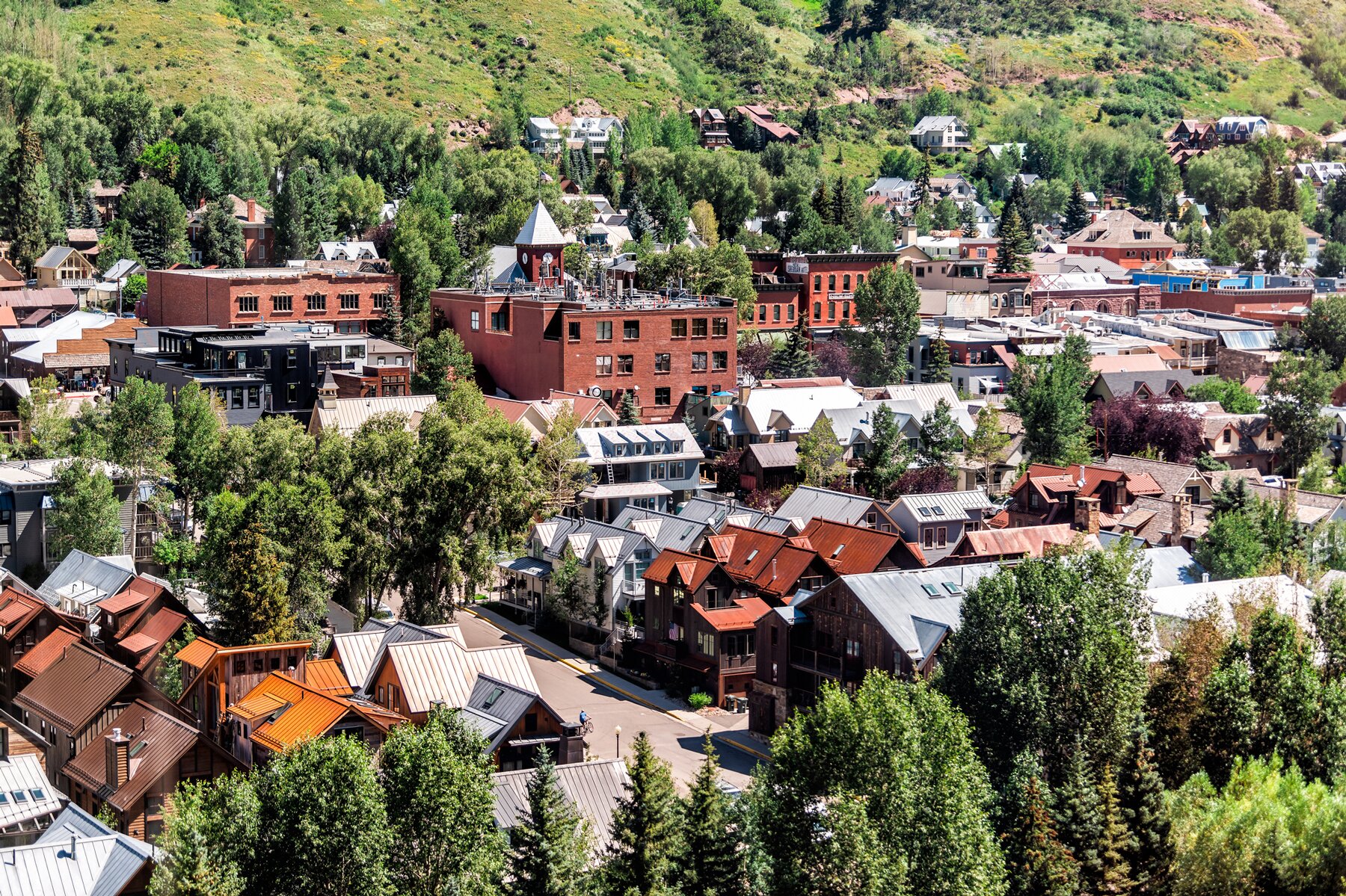 Telluride, Colorado small town with aerial high angle bird's eye view of city cityscape from free gondola to mountain village in summer